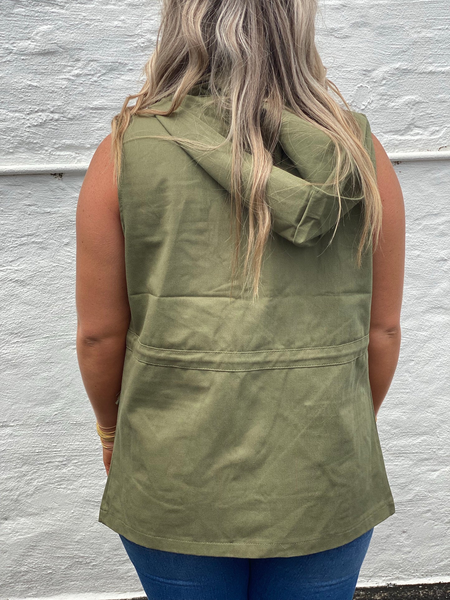 Army green cargo style vest with snap closure and tie waist