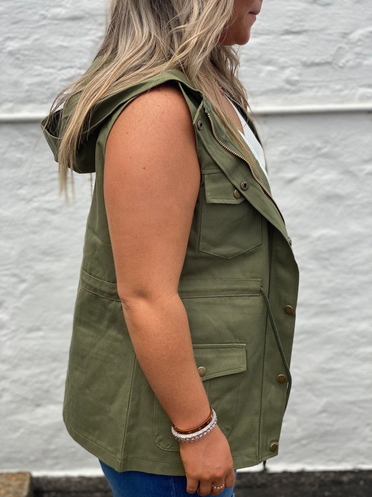 Army green cargo style vest with snap closure and tie waist